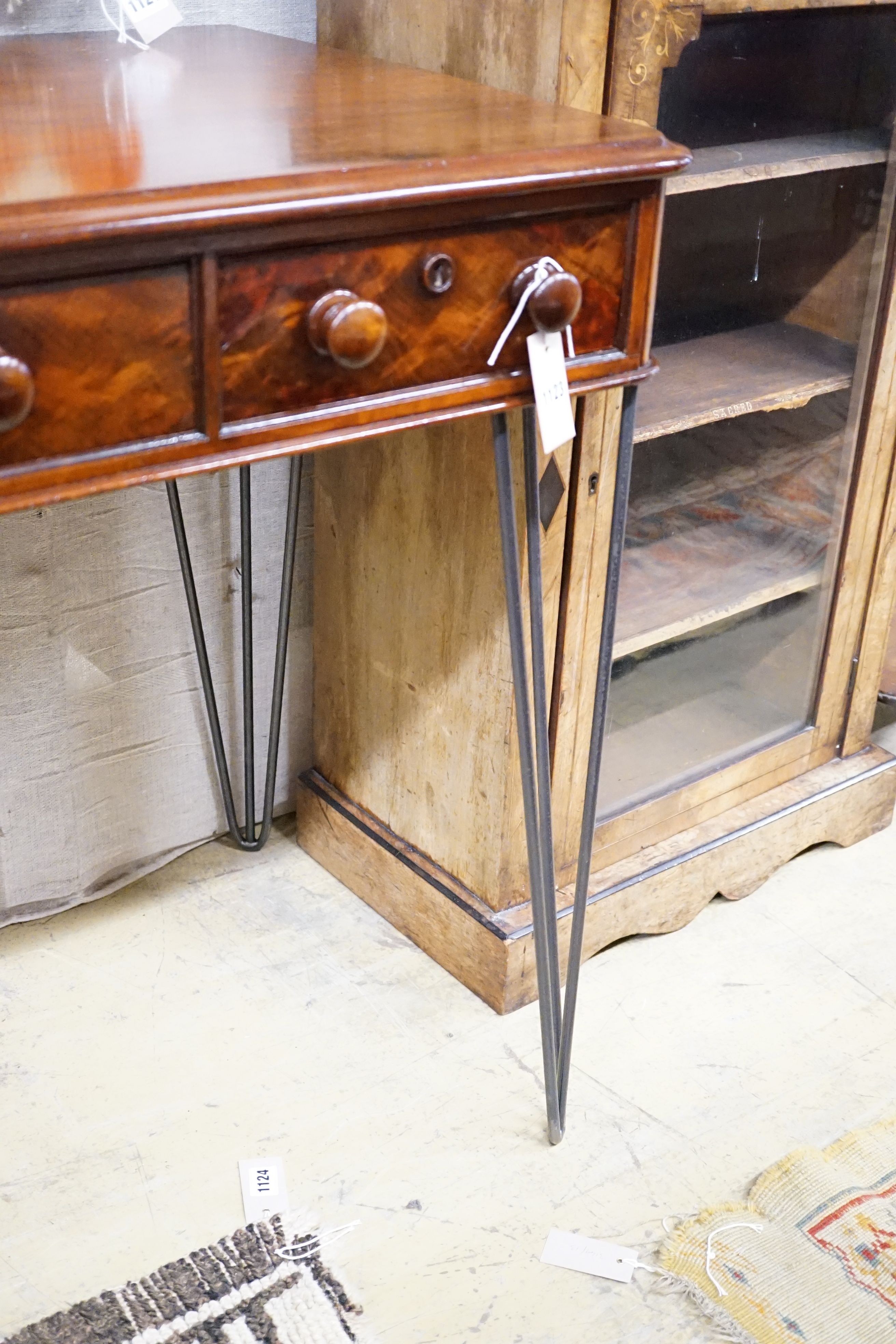 A Victorian mahogany writing table raised on later wrought iron legs, width 118cm, height 82cm